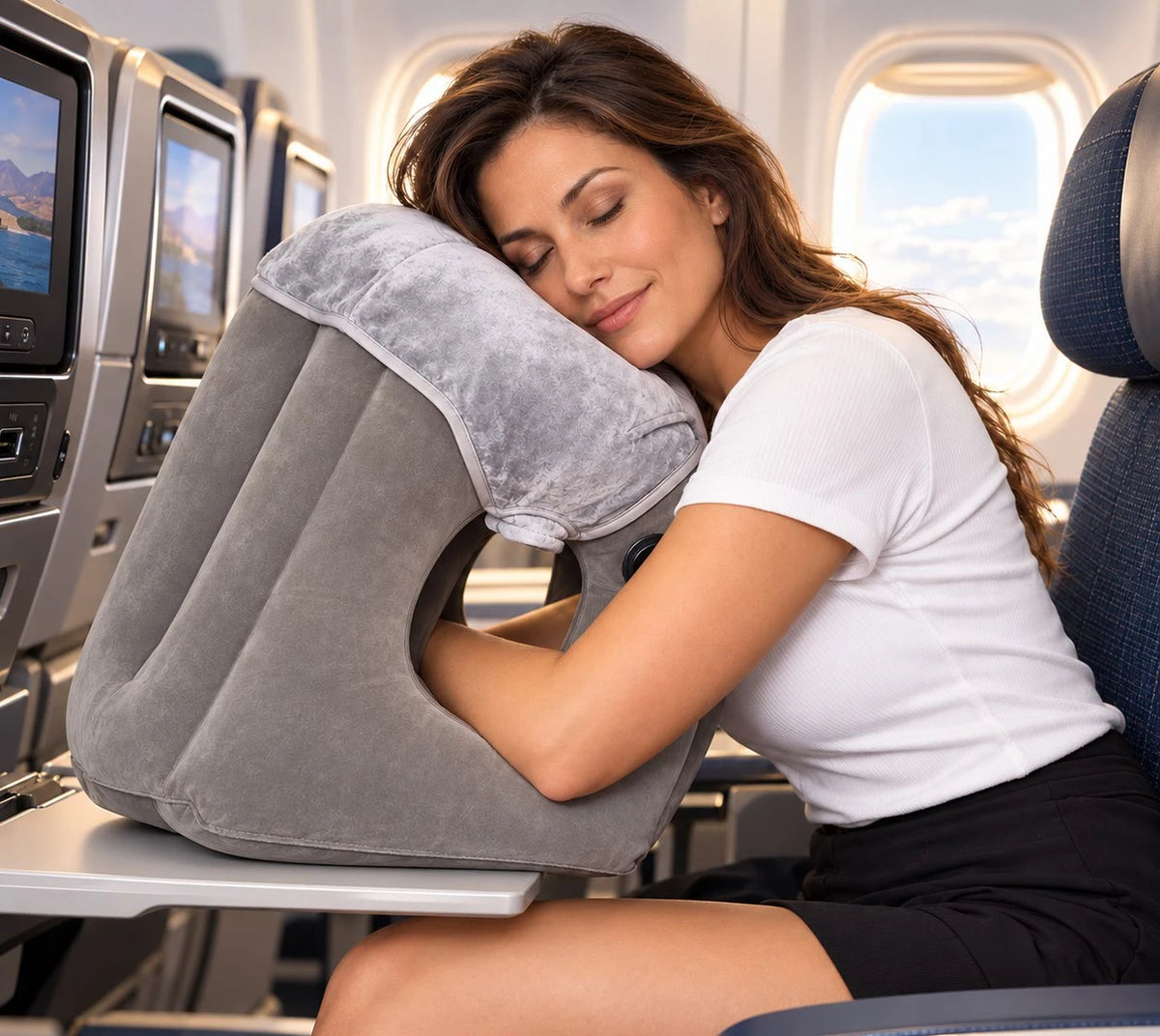 Traveler sleeping forward on AeroNestly Pro on an airplane tray table